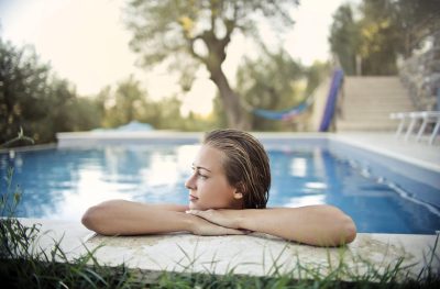 woman at pool and pool pump repairs services toronto